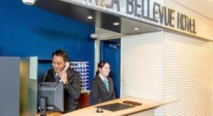 a man and a woman standing in front of a computer at Ginza Bellevue Hotel in Tokyo