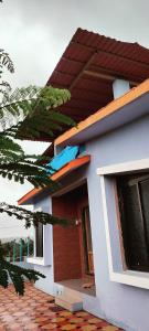 a small house with a red and white at Harekar Villa in Jalgaon