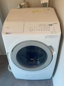 a white washing machine with a box on top of it at Wakaba Niseko 新築1棟貸切 in Rankoshi