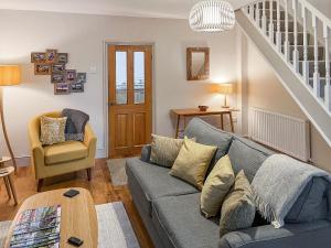 a living room with a couch and a stair case at Walkers Retreat in Crook