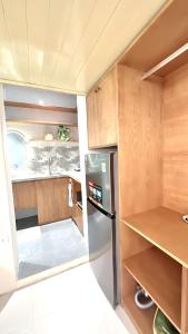 a small kitchen with a refrigerator and wooden cabinets at Hanoi An - 1'walk to Hoan Kiem lake - Hanoi Center in Hanoi