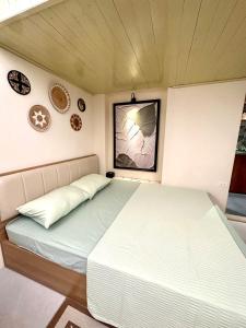 a large bed in a small room with at Hanoi An - 1'walk to Hoan Kiem lake - Hanoi Center in Hanoi