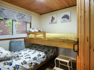 a bedroom with two bunk beds and a chair at The Owl's Nest - Uk50546 in Penegoes