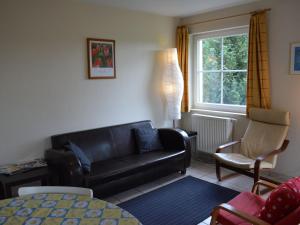 uma sala de estar com um sofá e uma cadeira em Hill View Apartment in Bouillon with Terrace em Bouillon