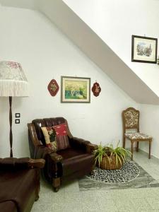 a living room with a couch and a chair at Centro Storico Di Tea in Turi +12 photos