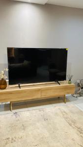 a large flat screen tv sitting on top of a table at Home away from Home in Maseru