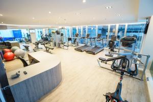 a gym with treadmills and cardio equipment in a building at New Season Square Hotel in Hat Yai