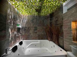 a bath tub in a bathroom with a ceiling at Apartamento con Jacuzzi privado Cerca al Metro y al Mayorca in Envigado +43 photos