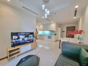 a living room with a couch and a flat screen tv at Rivergate Residence Central in Ho Chi Minh City