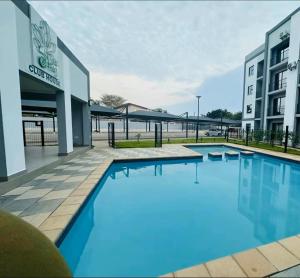a large swimming pool in front of a building at EchoPheme Suites in Gaborone