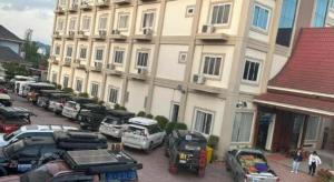 a group of cars parked in front of a building at Favanhmai Hotel in Muang Phônsavan