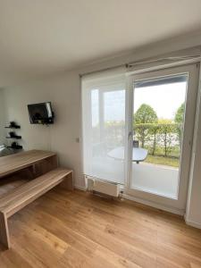 a room with a large sliding glass door with a window at Outletcity Apartment Ferienwohnung Metzingen in Metzingen