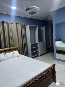 a bedroom with a bed and a large mirror at Your Home Away From Home, With Peace of Mind in Kweman