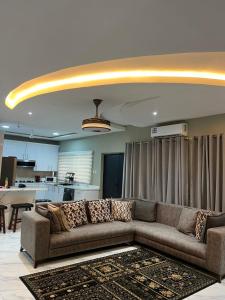 a living room with a couch and a kitchen at Your Home Away From Home, With Peace of Mind in Kweman
