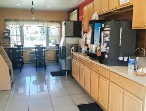 a kitchen with a counter with a coffee maker at Travelodge by Wyndham Bay Shore Long Island in Bay Shore