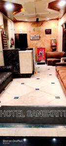 a room with couches and a hotel santicism at Hotel Sanskruti in Nagpur