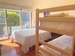 Un dormitorio con dos literas y una ventana. en Tomorrow Jervis Bay - Waterfront with Swimming Pool, en Callala Bay