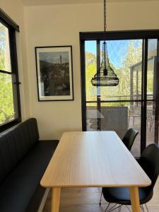 a living room with a table and a couch at Waldhütte your enchanting forest retreat! in Hepburn