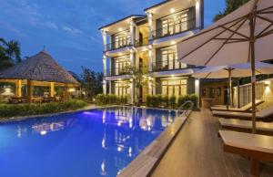 a swimming pool in front of a house at Friendly Villa Hoian in Hoi An