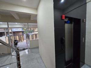 a hallway with a black door in a building at Vallimony Luxury Stays-Padmanabhaswamy Temple in Trivandrum