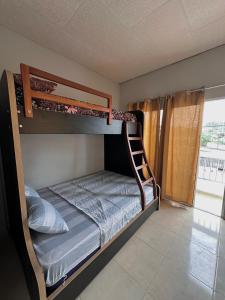a bedroom with two bunk beds with a ladder at Suites San José in San José +13 photos