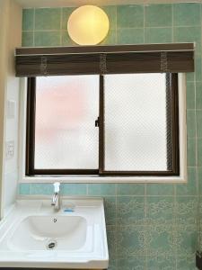 a bathroom with a sink and a window at Asakusa Sakura in Tokyo