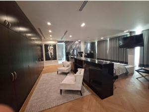 a bedroom with a desk and a bed with a piano at The Art Villa in Abu Dhabi +24 photos