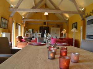 a table in a living room with a dining room at stylish holiday home in Rijsberge