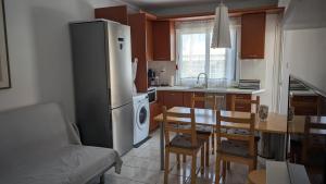a kitchen with a refrigerator and a table and chairs at Apartment 211 in Neoi Epivates