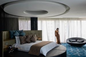 a bedroom with a bed and a chair in a room at W Doha in Doha +222 photos