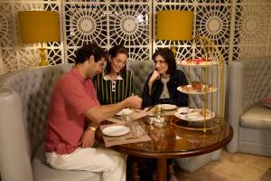 a group of people sitting around a table at W Doha in Doha
