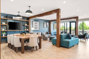 a dining room and living room with a table and chairs at Everhome Suites Bozeman in Bozeman