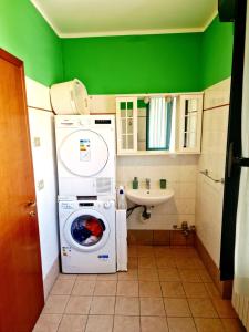 a small bathroom with a washing machine and a sink at BERNINA STATION CENTRE APARTMENT 4 - Tirano in Tirano