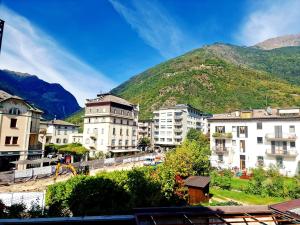 a city with buildings and a mountain in the background at BERNINA STATION CENTRE APARTMENT 4 - Tirano in Tirano +10 photos