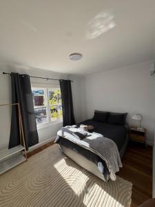 a bedroom with a bed and a window at Swansea Coastal Retreat Near Sea & IGA in Swansea