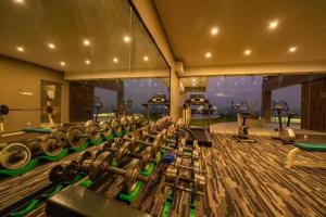 a gym with a bunch of dumbbells in a room at Hotel Castle Salam in Khulna