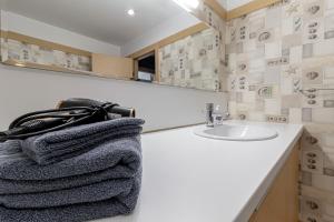 a bathroom with a sink and a towel at Comfort & Views over Riga Apartment near Airport and City Center in Rīga +24 photos