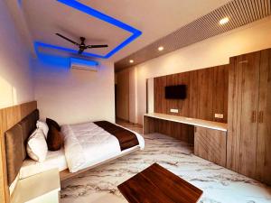 a bedroom with a bed and a ceiling fan at Horizon Banquet Pushkar - with Mountain View in Pushkar