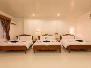 a bedroom with three beds in a room at Asia Hotel in Phnom Penh