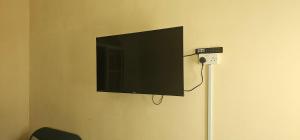 a flat screen tv hanging on a wall at هومي in Salalah +27 photos