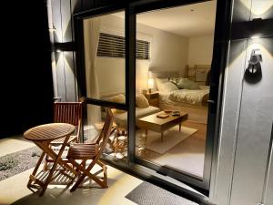 a living room with a couch and a table at The Mann Homestay, Premium King Room with Private Ensuite, Near Waihi & Coromandel in Waihi