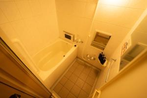 a bathroom with a shower and a tub at Sapporo Bios Hall 1215 - Vacation STAY 16760 in Sapporo +18 photos