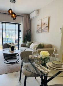 a living room with a couch and a table at Kappa Haven in Gaborone