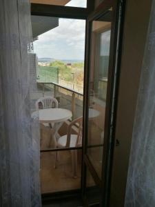 a view of a balcony with a table and chairs at Sunshine Apartment in Pomorie +24 photos