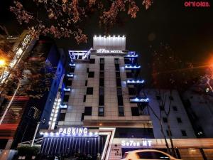 a building with blue lights on top of it at Seven Motel Ansan in Ansan