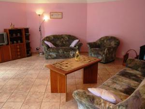 a living room with two couches and a coffee table at Comfortable detached house with large garden in Klokočí