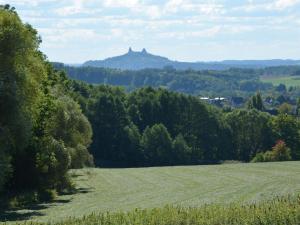 a field of grass with a castle in the distance at Comfortable detached house with large garden in Klokočí