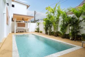 a swimming pool in the backyard of a house at Goldena Residence Private Pool Villas in Kamala Beach