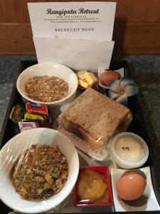 a tray of food with eggs bread and other ingredients at Rangiputa Retreat in Karikari Peninsula