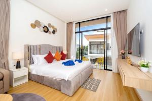 a bedroom with a large bed and a tv at Goldena Residence Private Pool Villas in Kamala Beach +117 photos